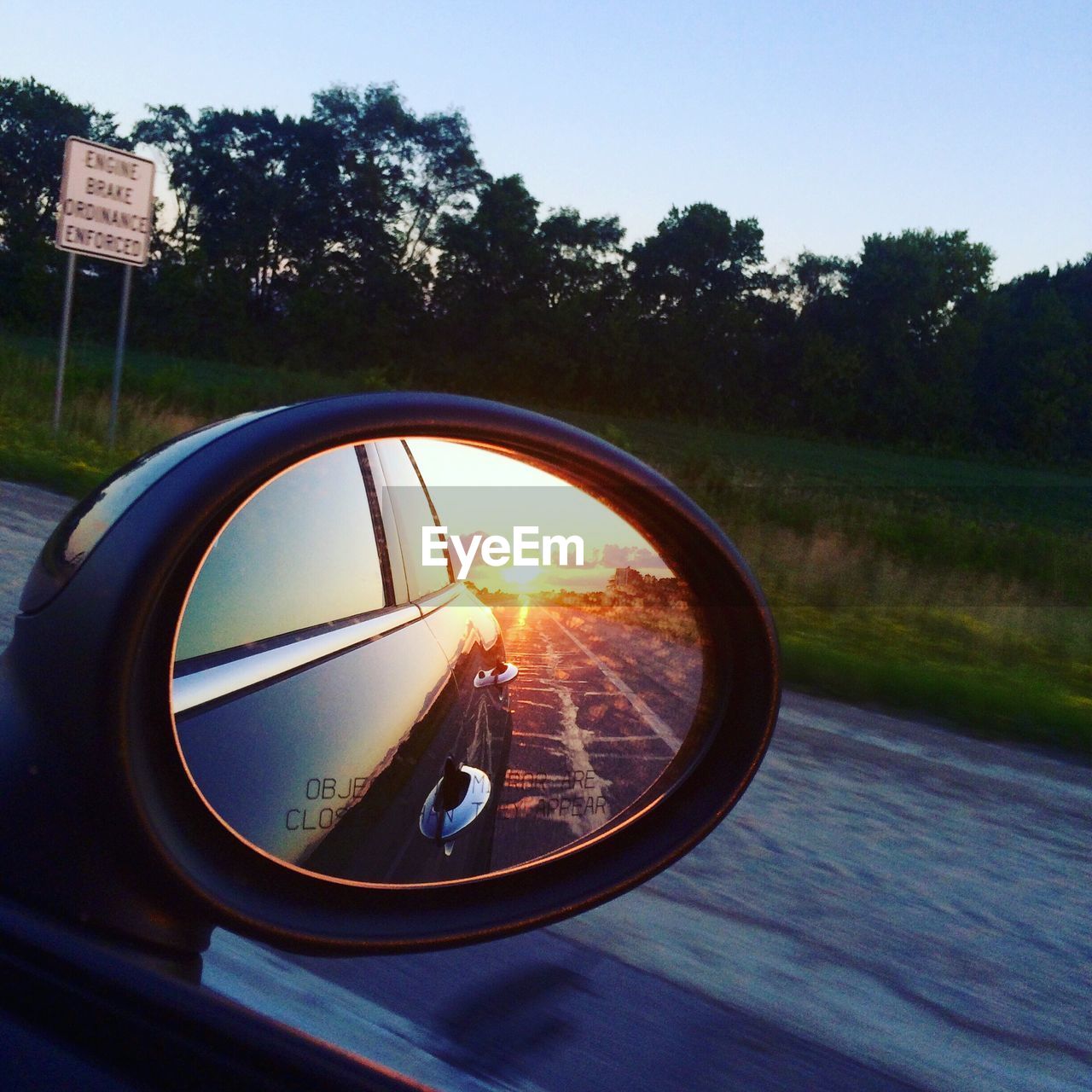 Reflection of road on side-view mirror of car