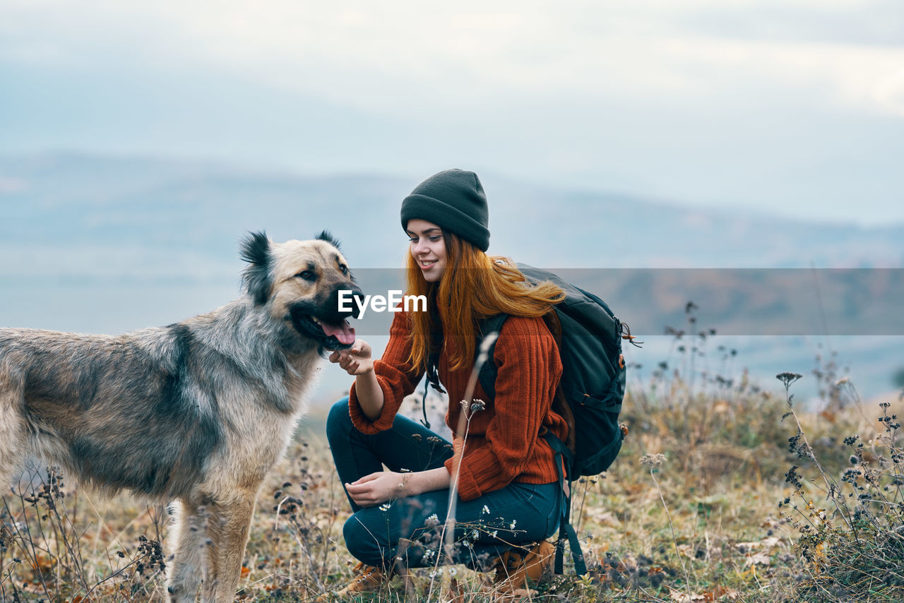 YOUNG MAN WITH DOG ON THE BACKGROUND