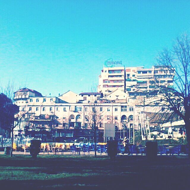 BUILDINGS IN CITY AGAINST BLUE SKY