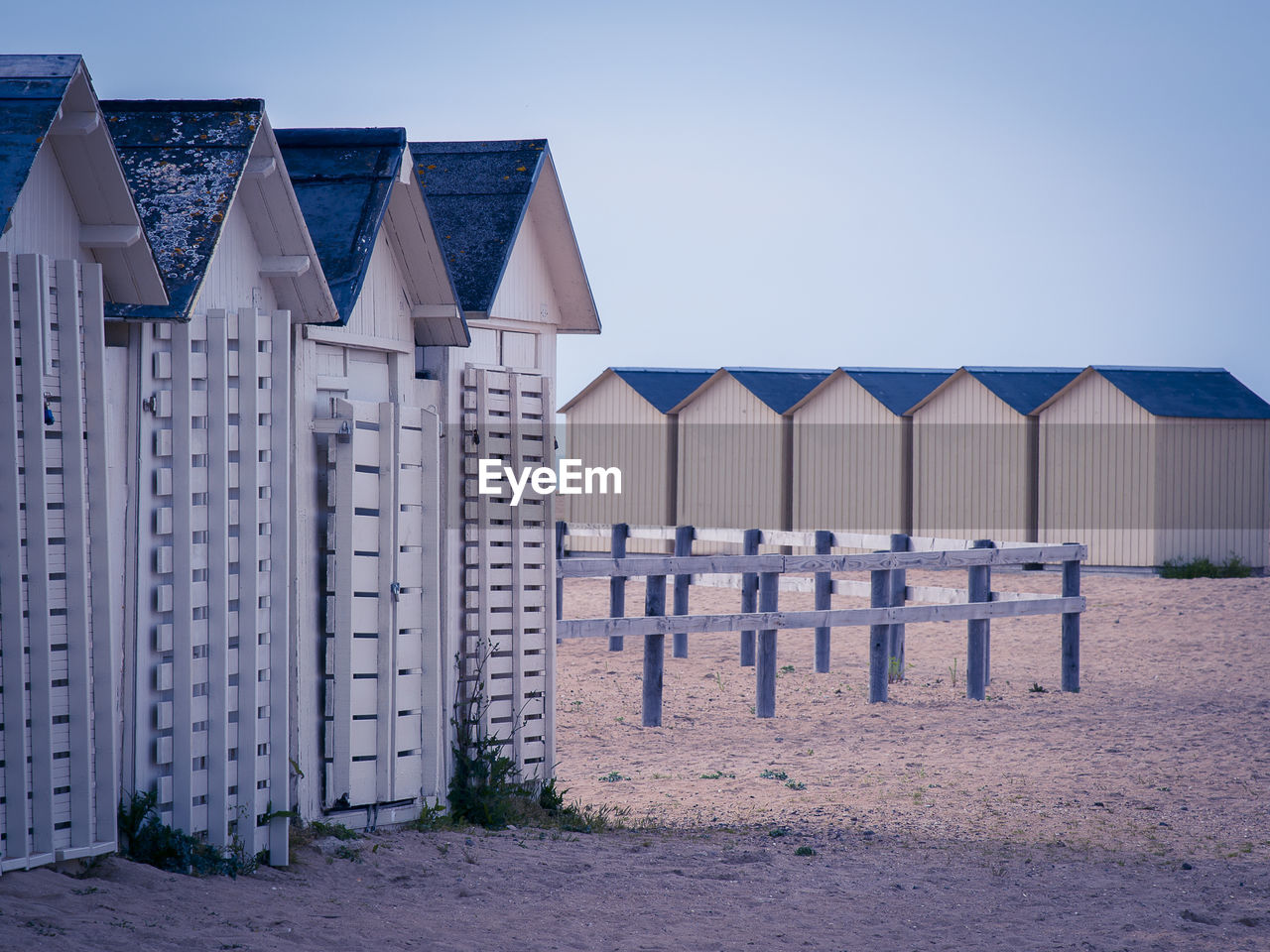 Row of houses on beach against clear sky