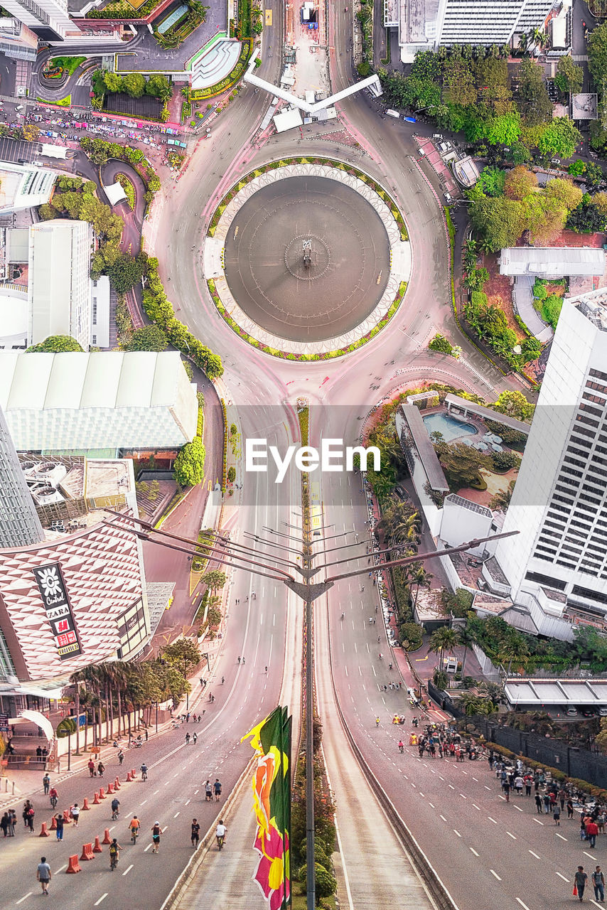 HIGH ANGLE VIEW OF ROAD AMIDST BUILDINGS