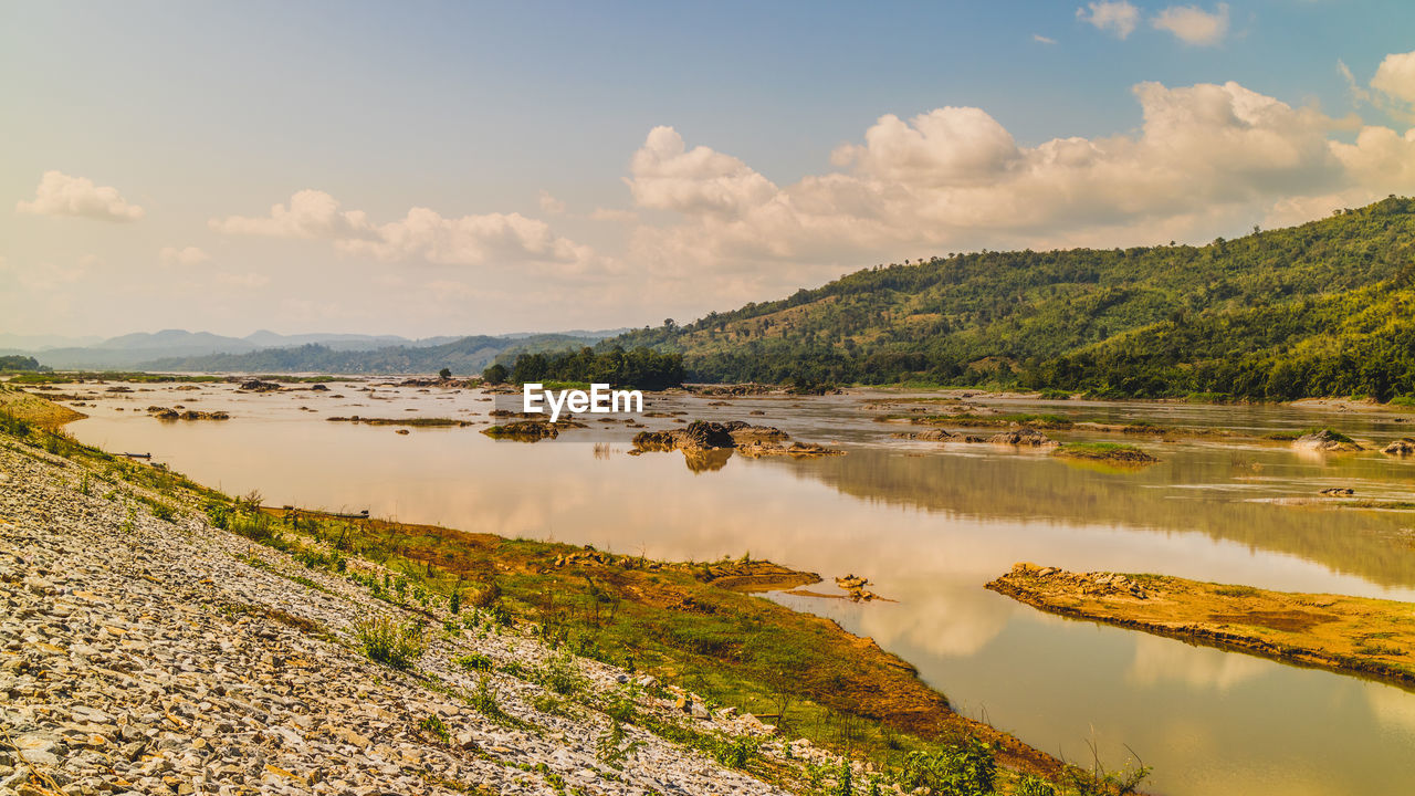 PANORAMIC VIEW OF LAKE AND ROCKS AGAINST SKY