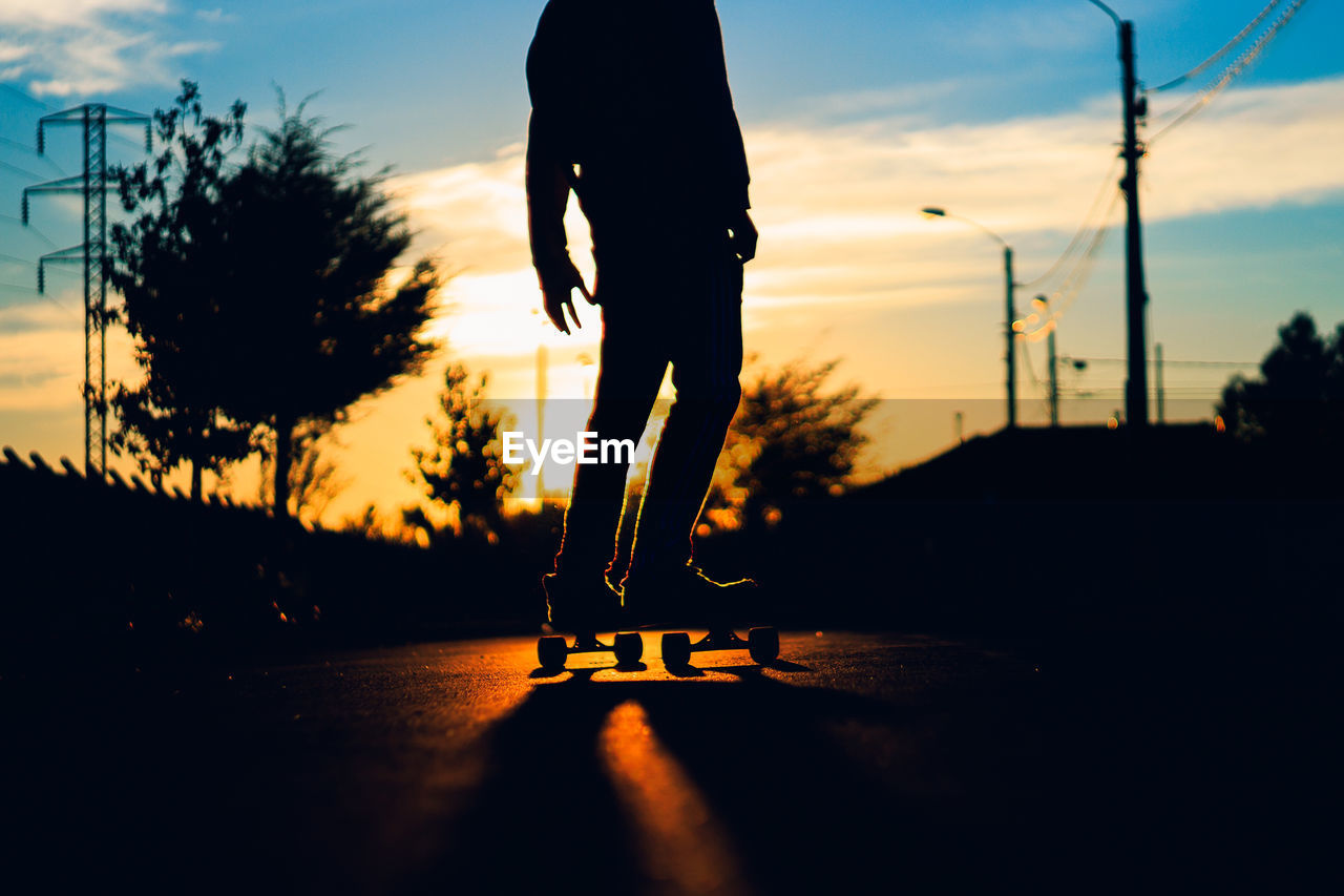 Silhouette of man on skateboard