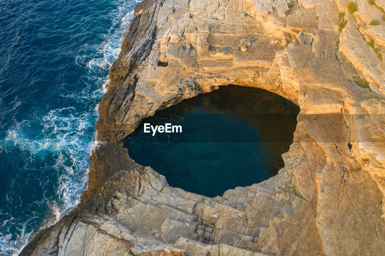 High angle view of rock formations in sea