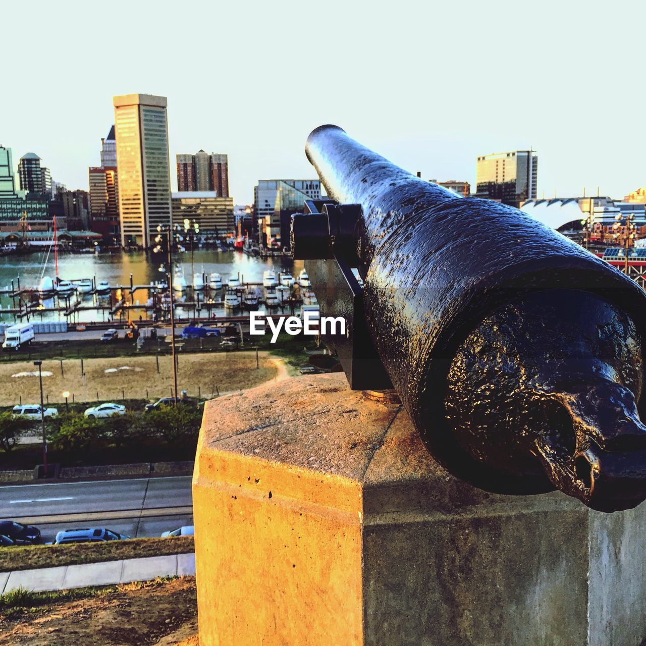 CLOSE-UP OF MAN WITH CITYSCAPE IN BACKGROUND