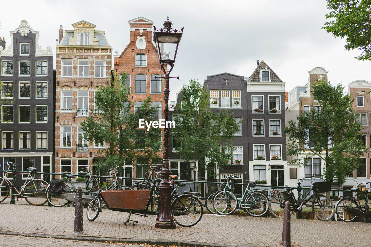 Bicycles on street by buildings in city