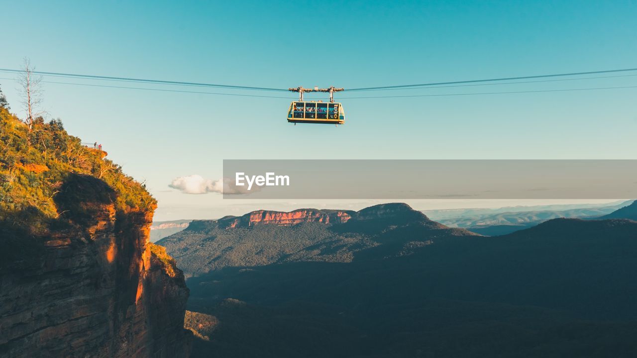 LOW ANGLE VIEW OF OVERHEAD CABLE CARS