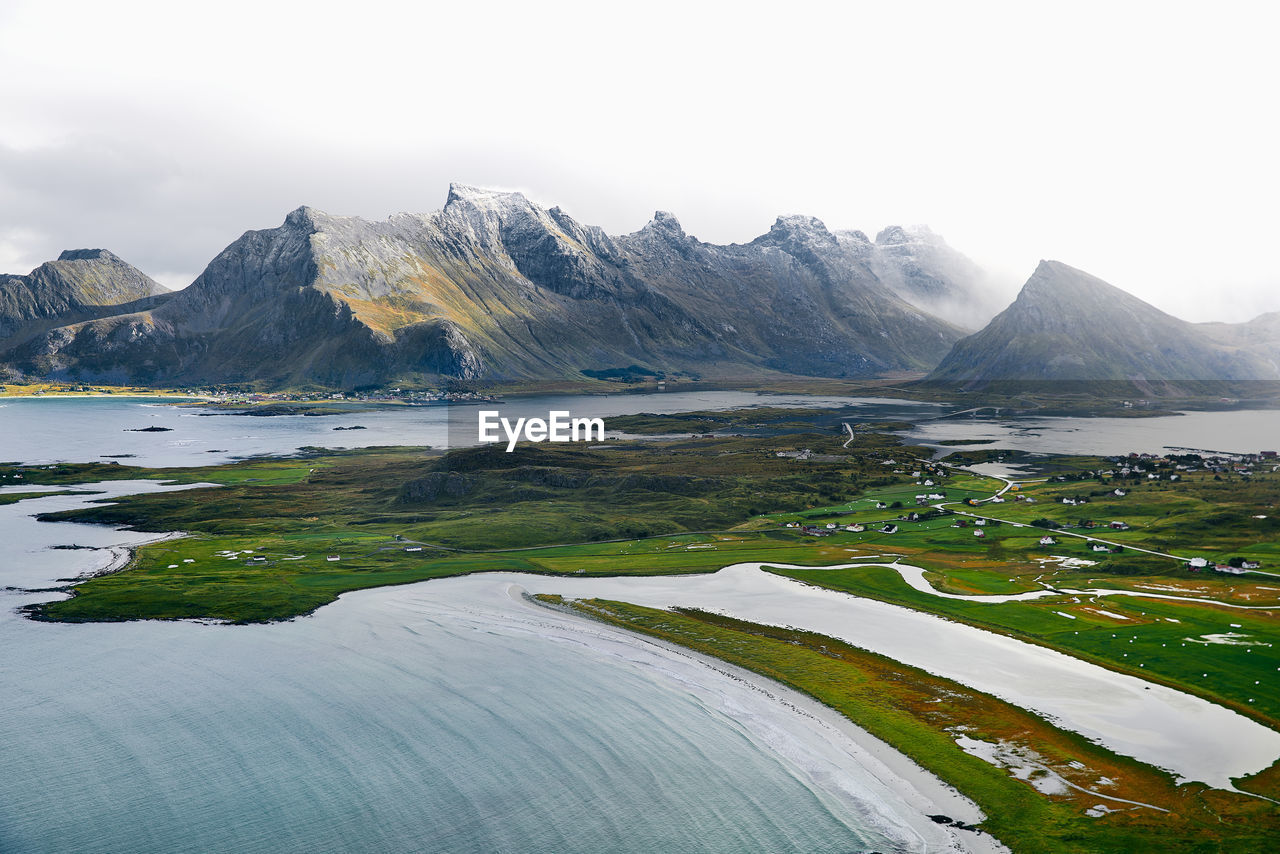 Scenic view of lake and mountains against sky