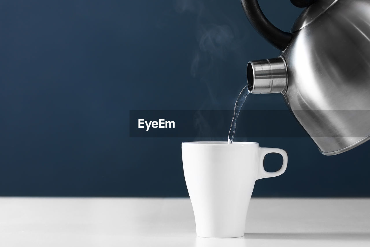 CLOSE-UP OF COFFEE CUP ON GLASS
