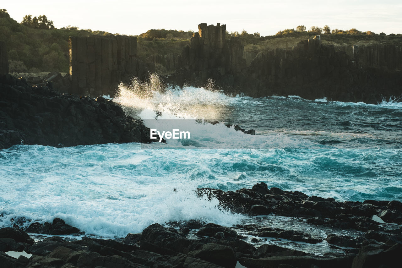 Waves splashing on rocky shore