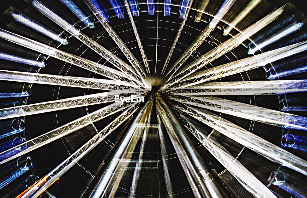 Full frame shot of illuminated ferris wheel at night