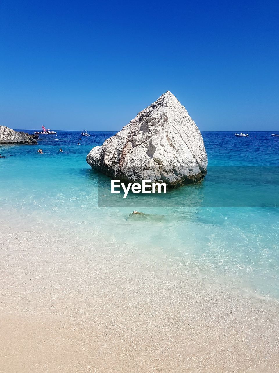 Scenic view of sea against clear blue sky