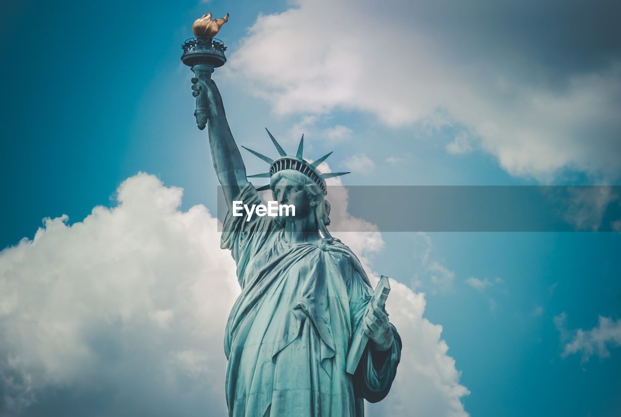 Low angle view of statue against cloudy sky