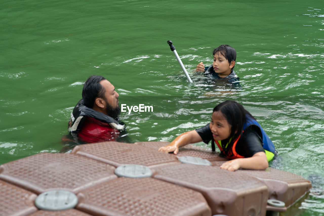 FRIENDS SITTING ON BOAT