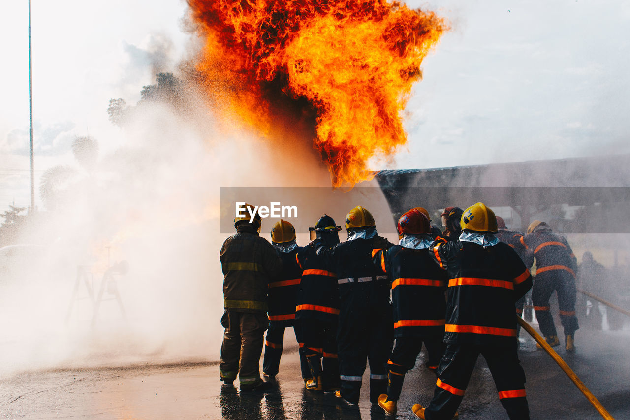 PEOPLE STANDING BY FIRE HYDRANT AGAINST WALL