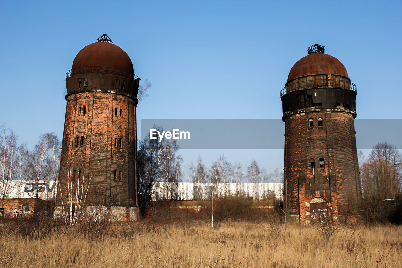 Old water tower against sky