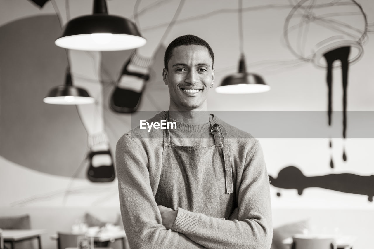 portrait of young man standing at gym