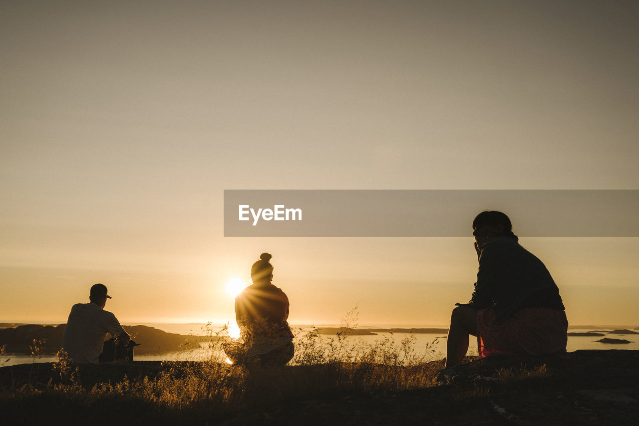 Silhouettes of people at sunset