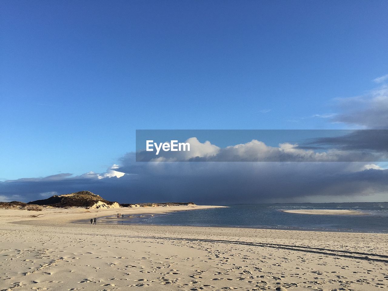 Scenic view of beach against blue sky