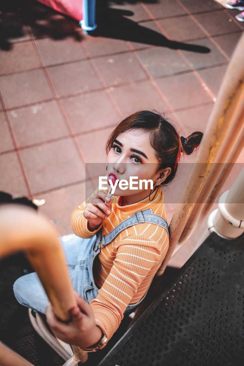 Portrait of young woman eat candy