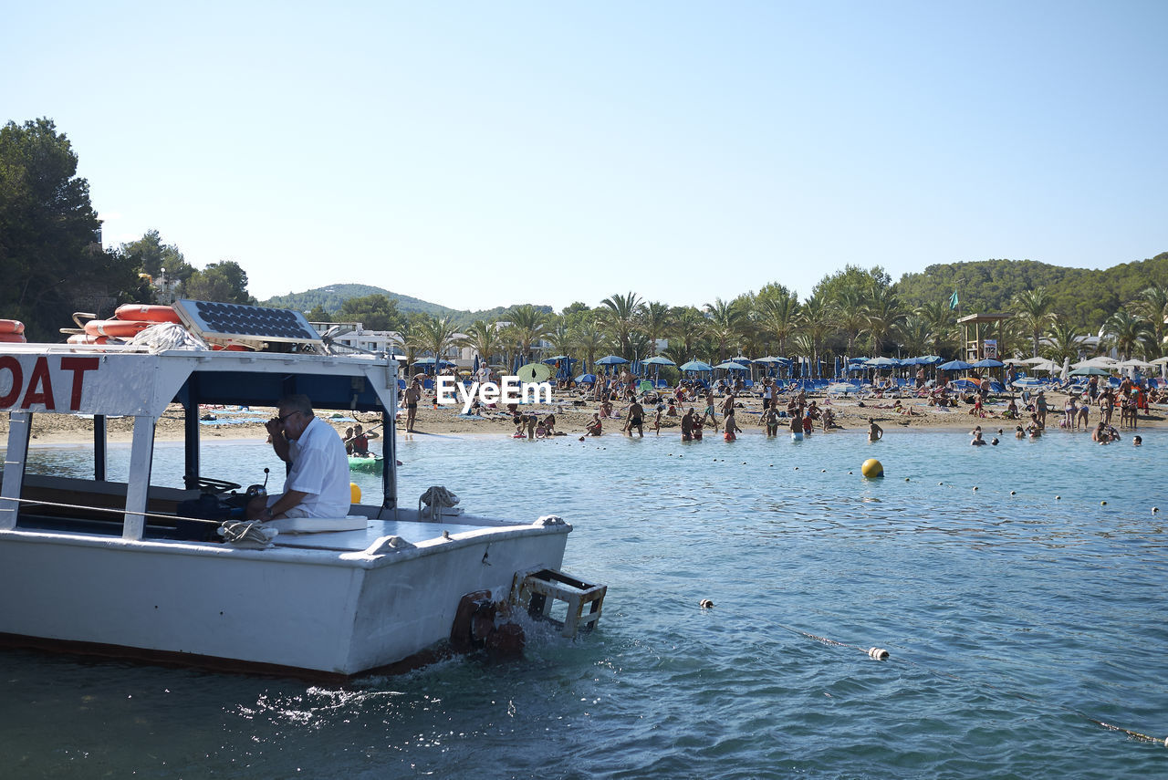 GROUP OF PEOPLE ON BOAT IN SEA