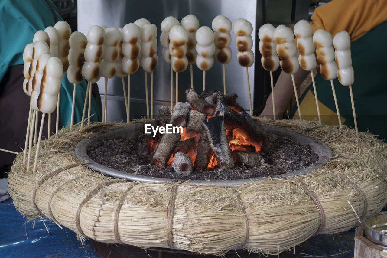 CLOSE-UP OF BARBECUE GRILL IN CONTAINER