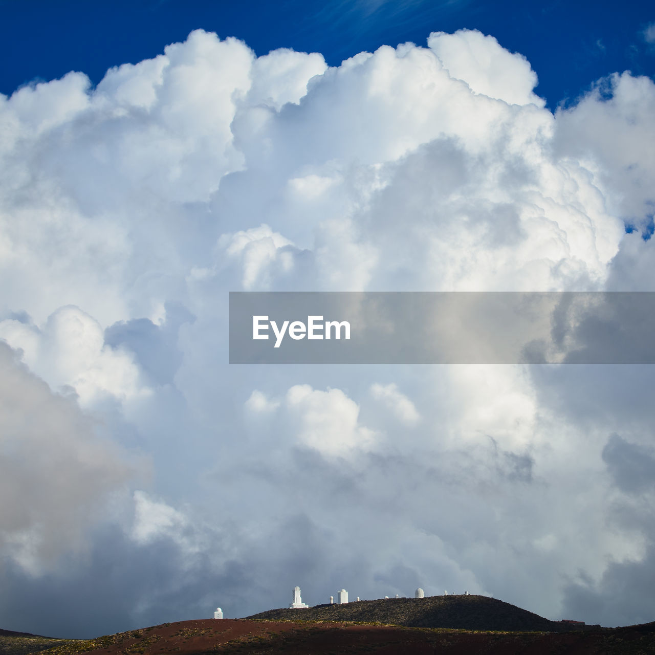 LOW ANGLE VIEW OF CLOUDS OVER BUILDING