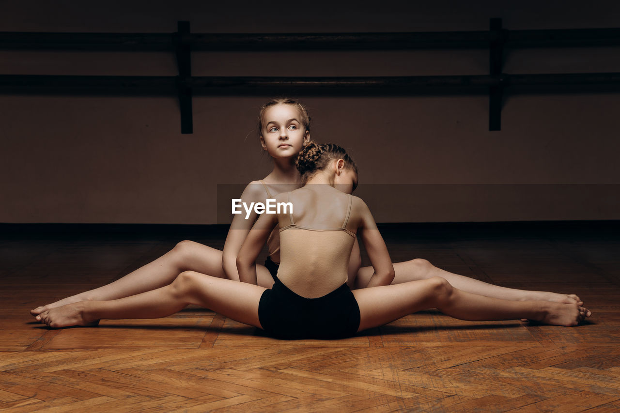 Young woman sitting on floor