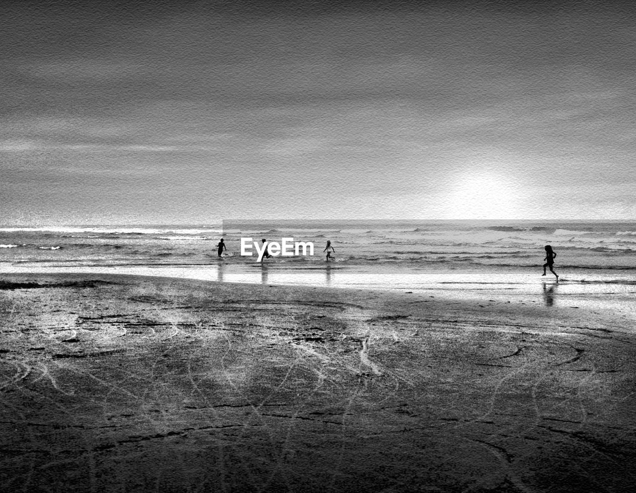 PEOPLE ENJOYING ON BEACH AGAINST SKY