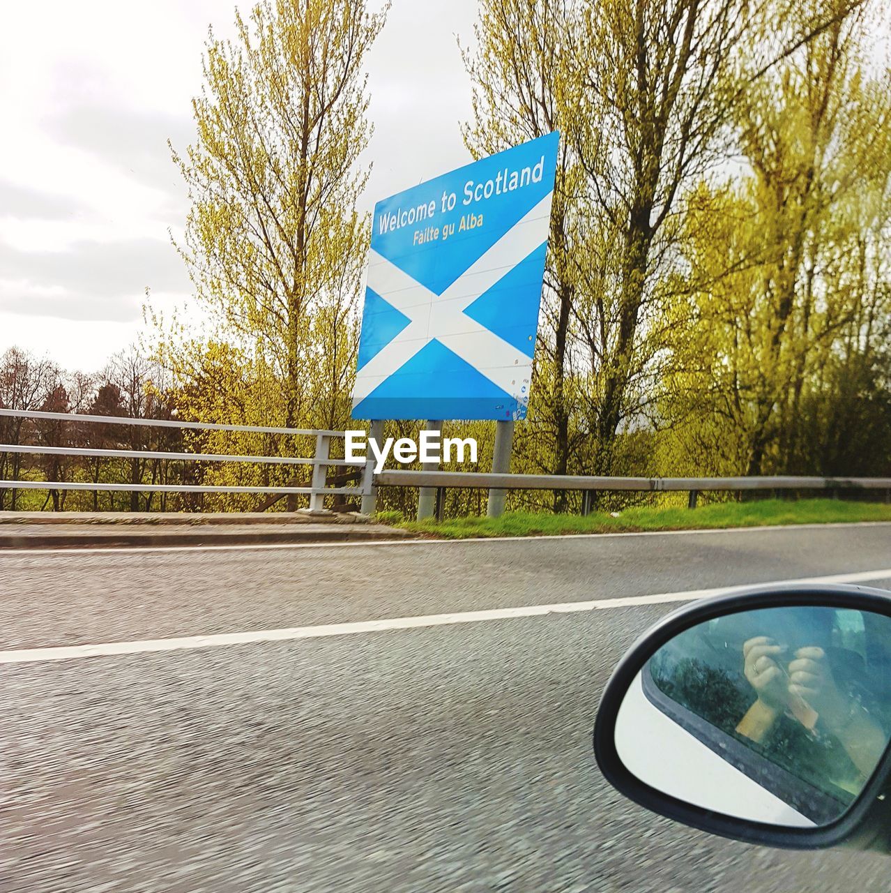 CLOSE-UP OF ROAD SIGN AGAINST TREES