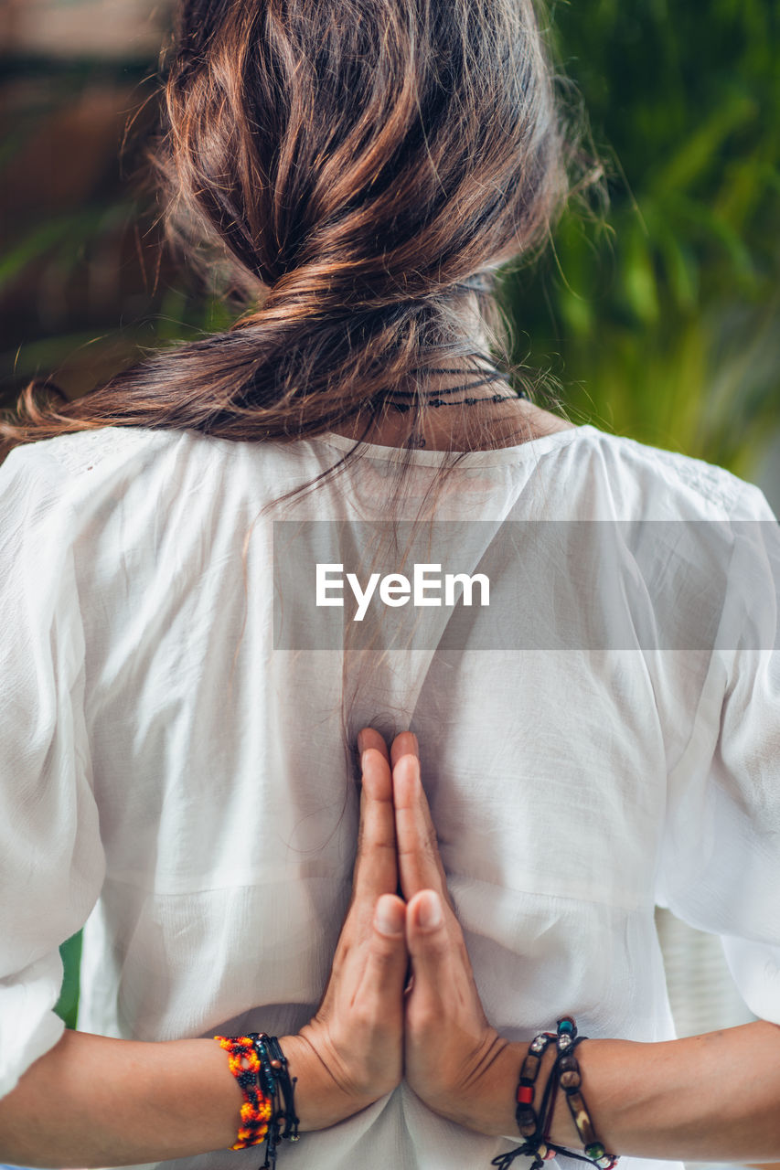 Rear view of young woman doing yoga