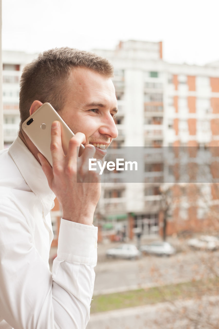 Side view of man talking on phone