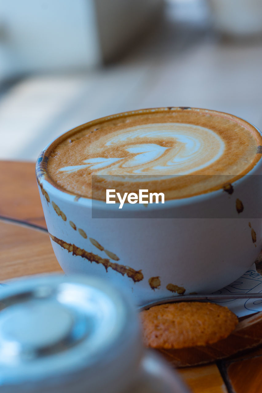 food and drink, coffee, drink, cup, mug, coffee cup, hot drink, refreshment, cappuccino, frothy drink, food, still life, latte, crockery, saucer, no people, froth art, close-up, selective focus, table, cafe, flat white, kitchen utensil, indoors, baked, spoon, dessert