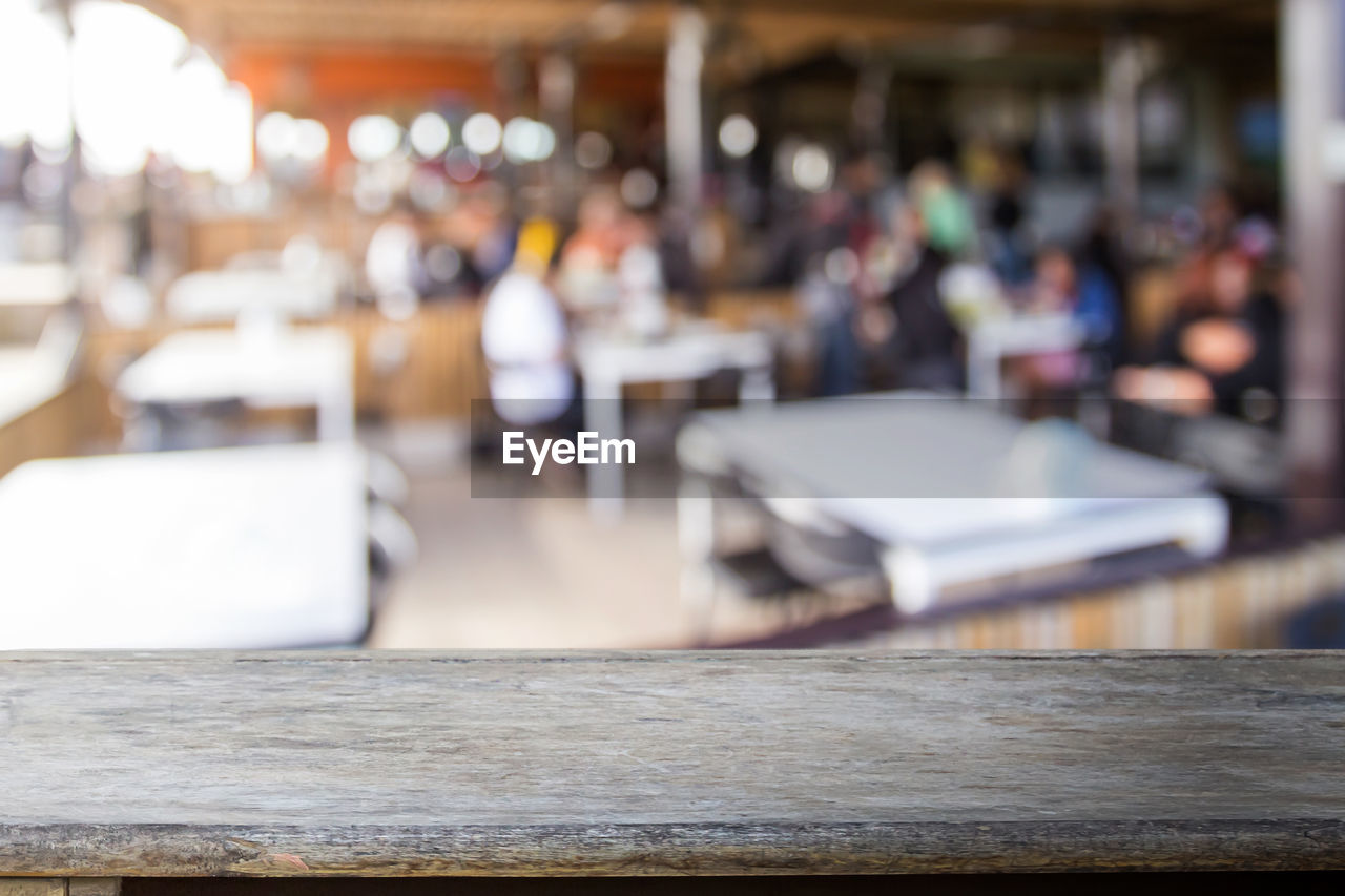 table, cafe, restaurant, business, wood, seat, focus on foreground, architecture, food and drink, furniture, day, indoors, chair, selective focus, travel, relaxation