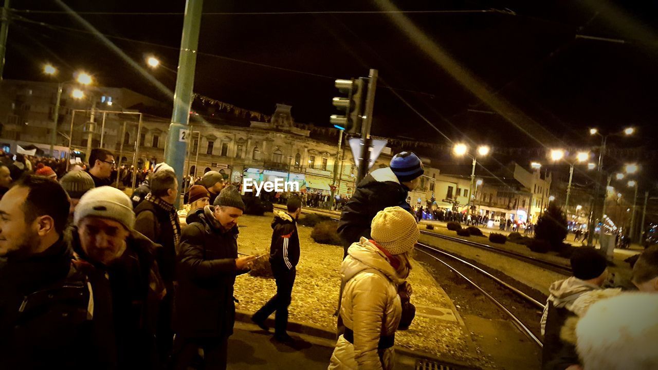 MEN ON ILLUMINATED MARKET