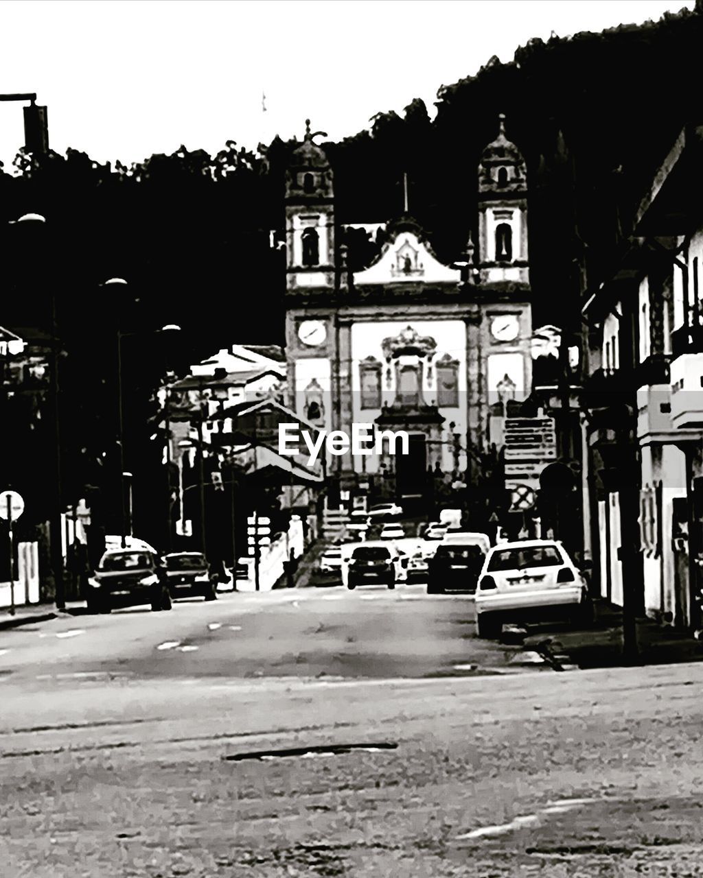 CARS ON ROAD AGAINST BUILDINGS