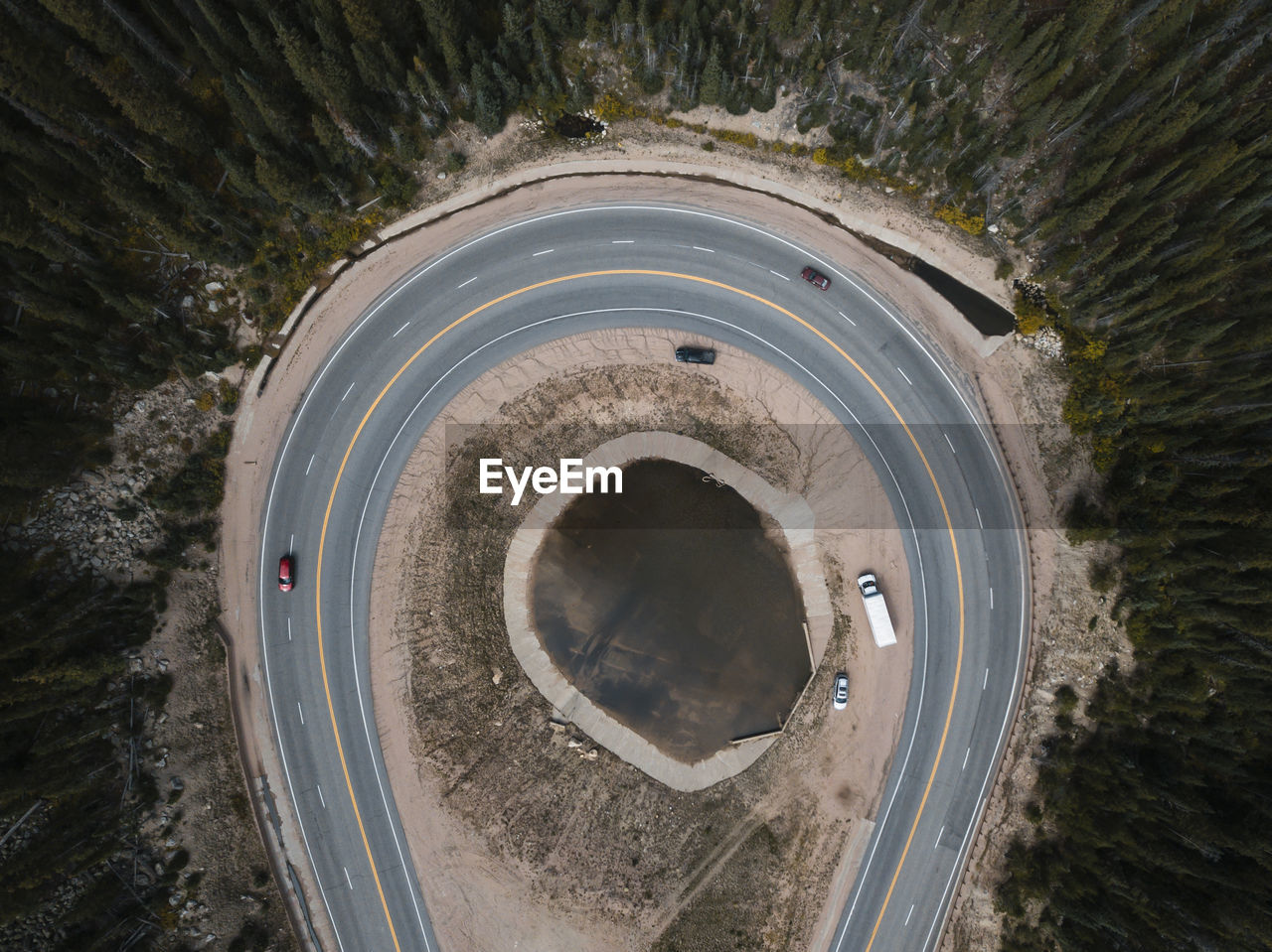 Aerial view of vehicles on road amidst trees