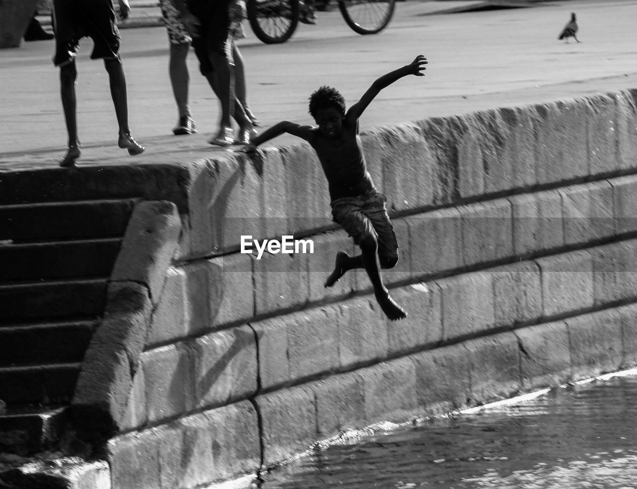 PEOPLE JUMPING ON SEA SHORE