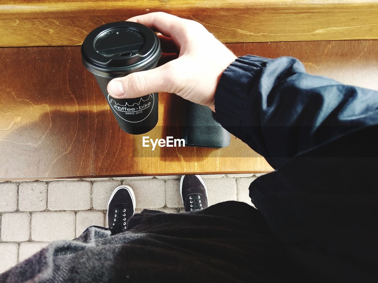 LOW SECTION OF MAN PHOTOGRAPHING WITH CAMERA ON FLOOR