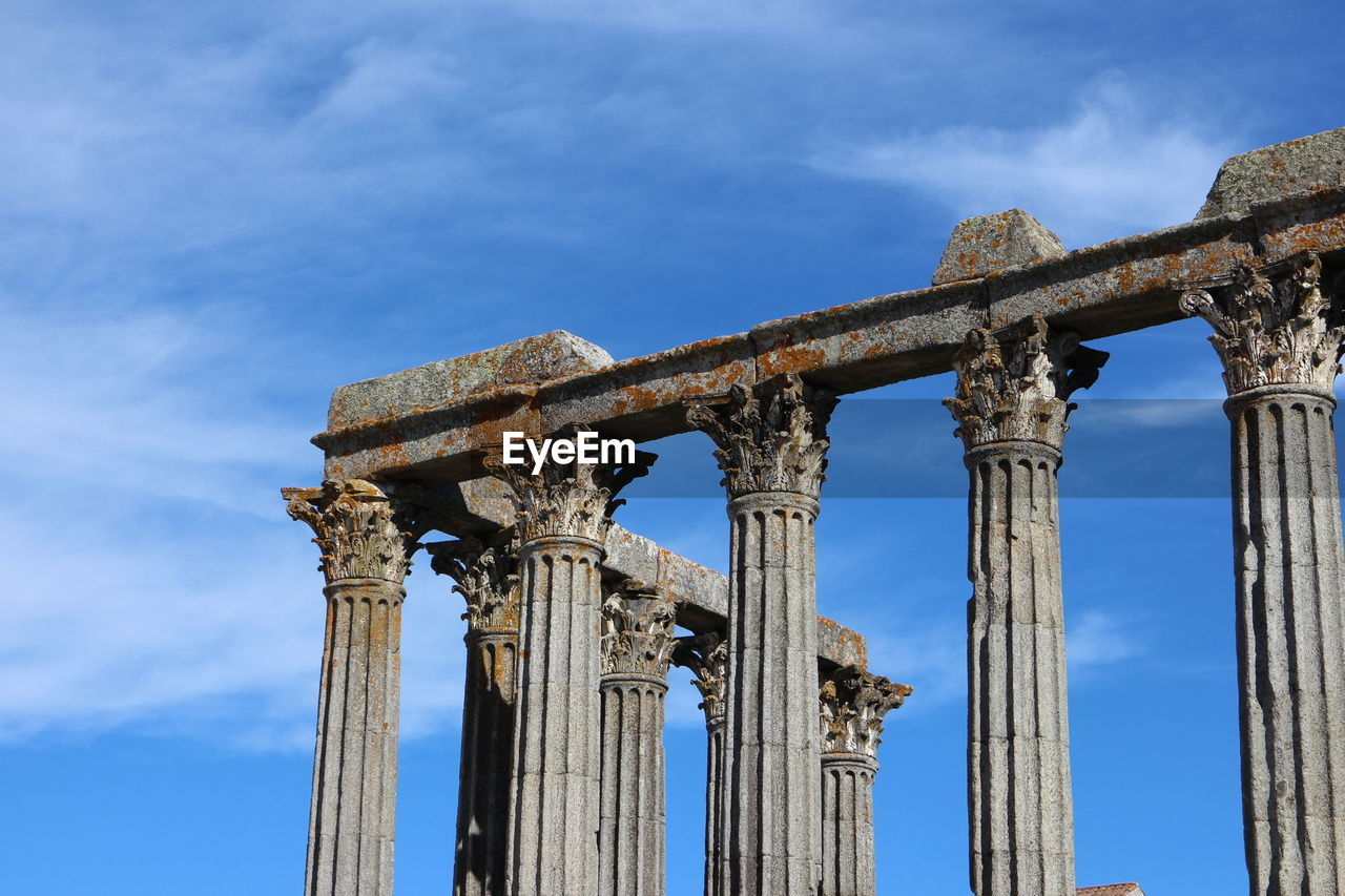 Low angle view of columns at roman temple of evora against sky
