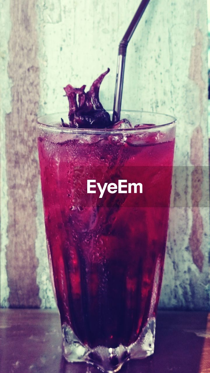 Close-up of pomegranate juice in glass with ice