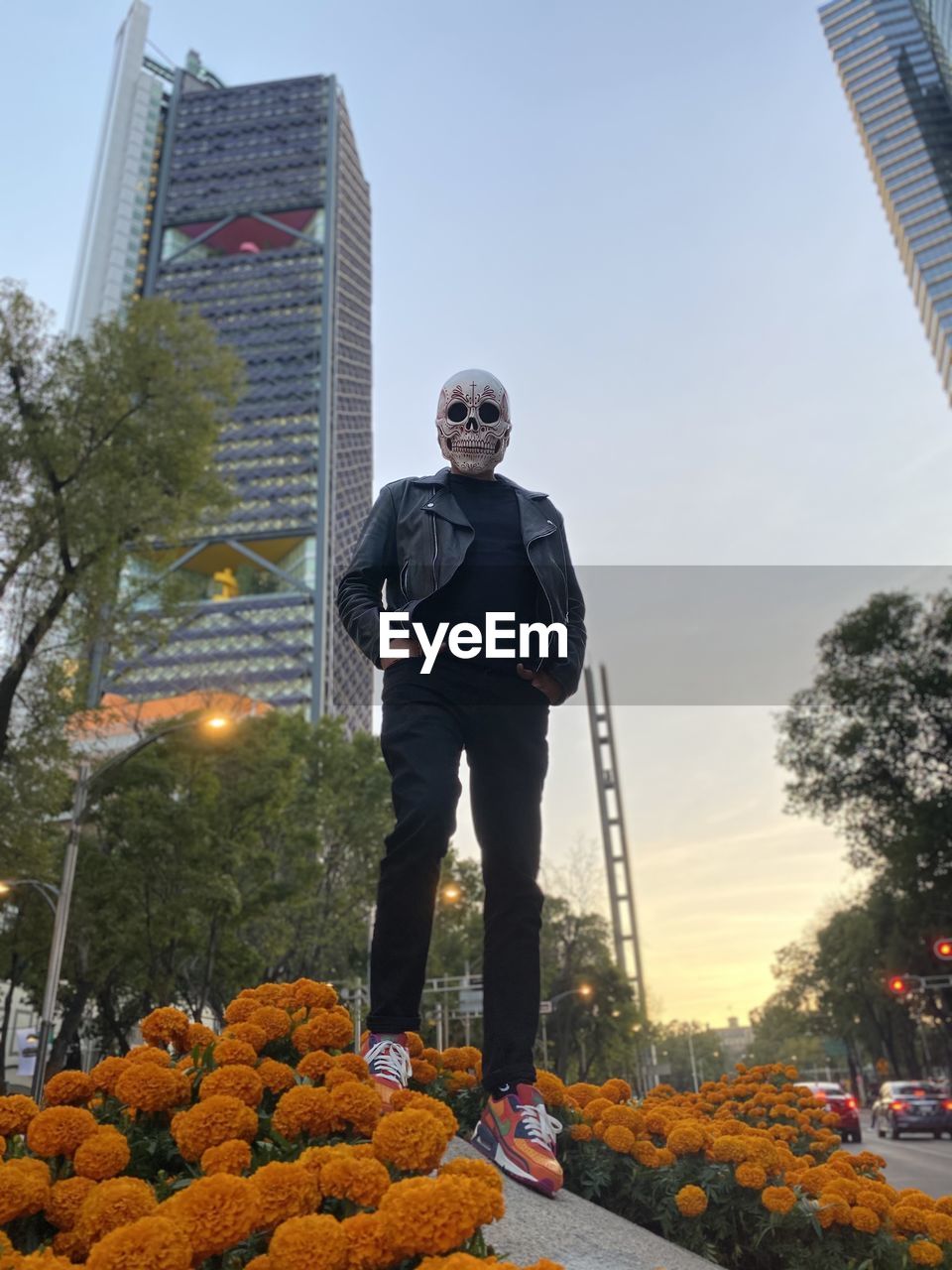 MAN STANDING AGAINST SKY IN CITY