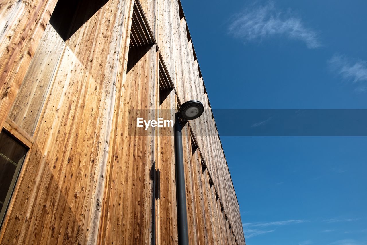 Low angle view of clock against blue sky