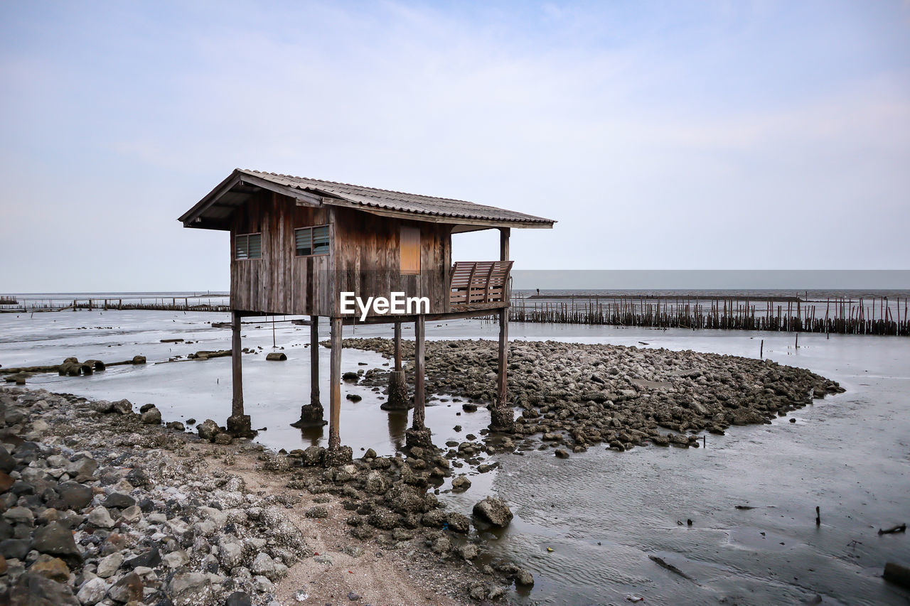 Built structure on beach against sky