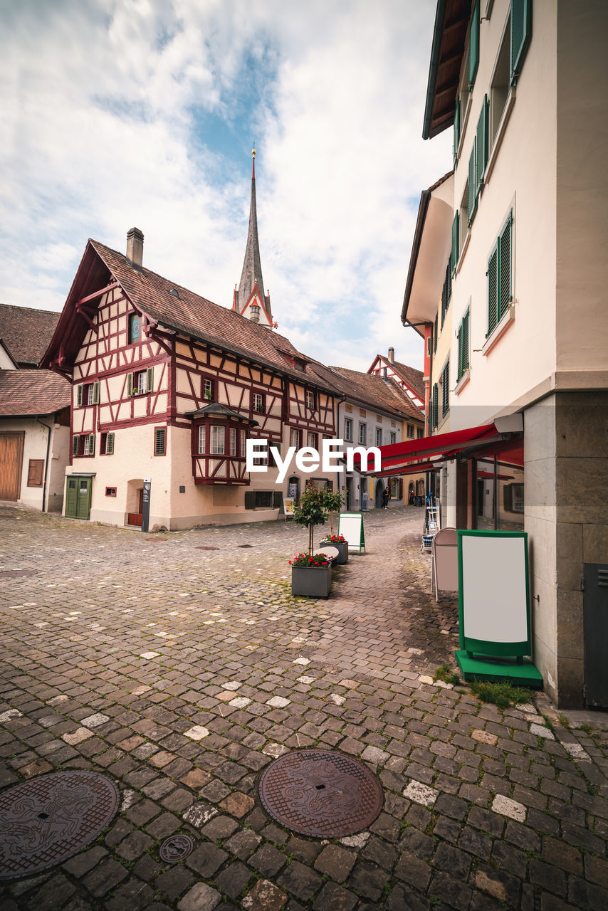 FOOTPATH AMIDST BUILDINGS IN TOWN