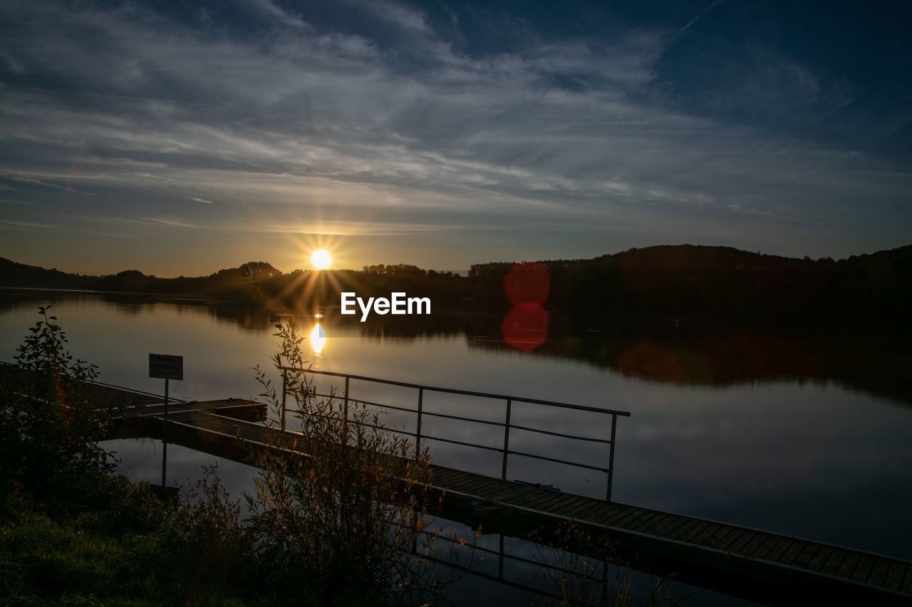 Scenic view of lake against sky during sunset