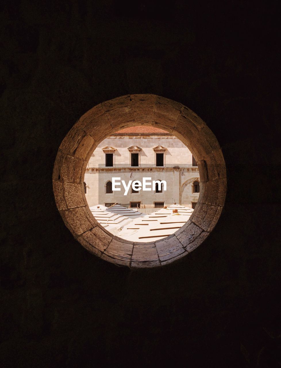 VIEW OF BUILDING THROUGH HOLE