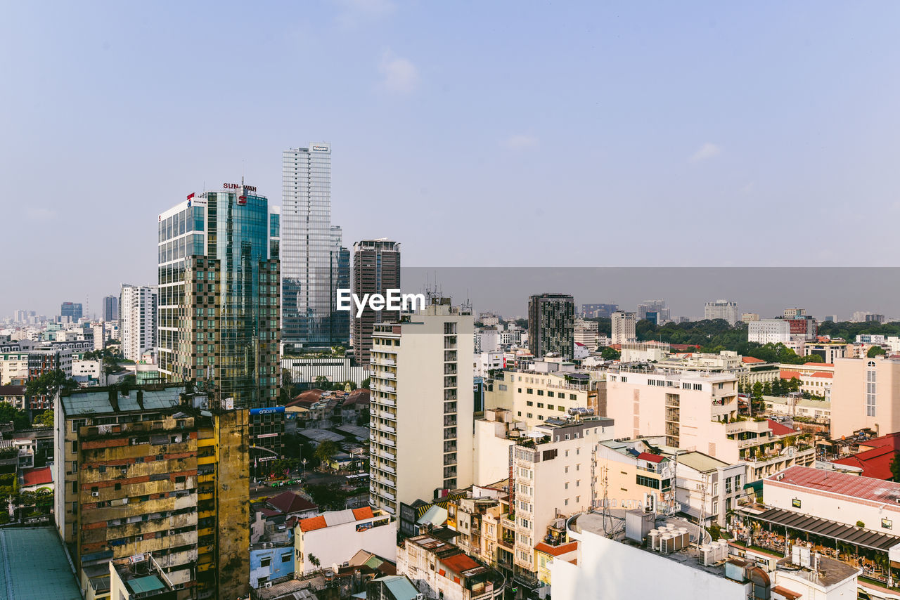 High angle view of modern buildings in city against sky