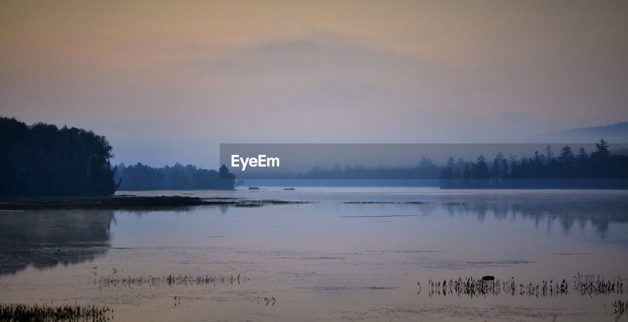 Scenic view of lake against sky during sunset