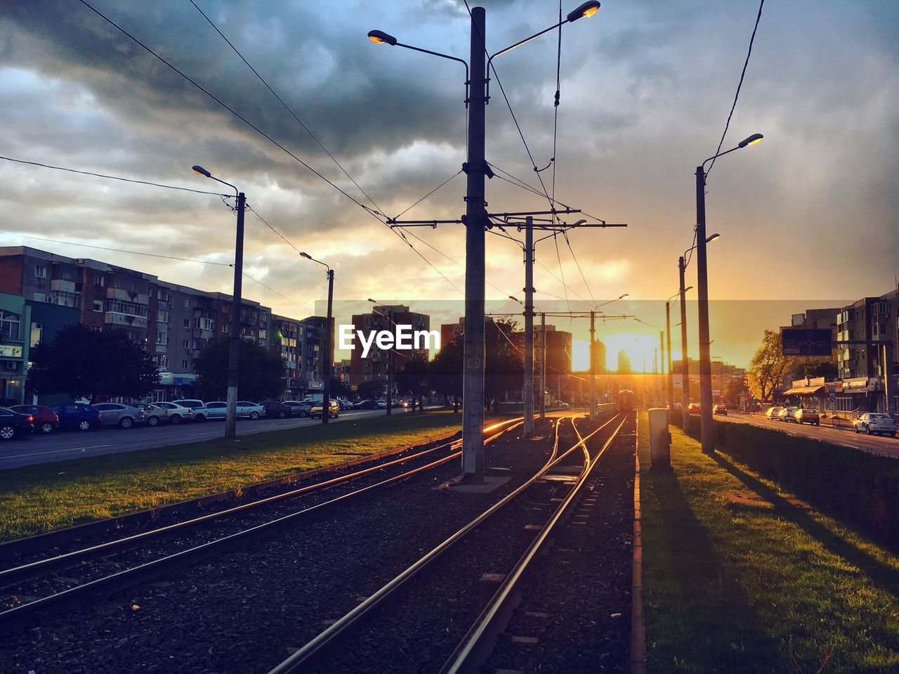 RAILROAD TRACKS AGAINST SKY DURING SUNSET